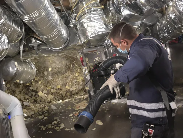 Northbridge Air Duct Cleaning specialist operating negative pressure cleaning equipment for thorough duct maintenance in Northbridge